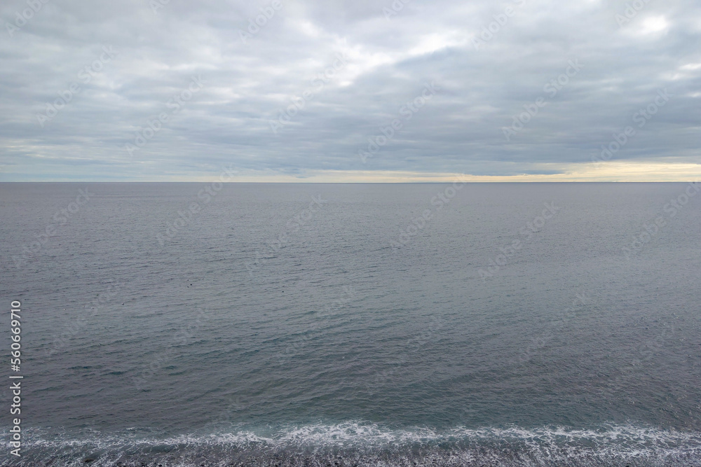 Beautiful views of the Atlantic Ocean and gray skies. The background of nature.