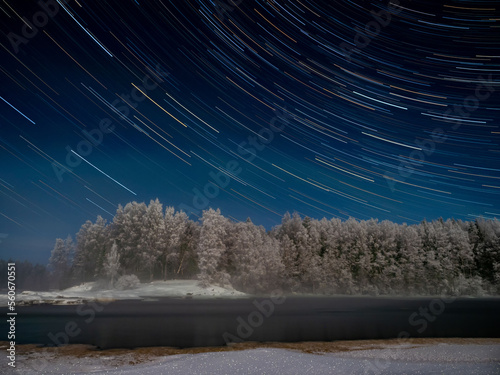 Star tracks shot at long exposure on a frosty night in January on the Shuya River in Karelia, northwest Russia