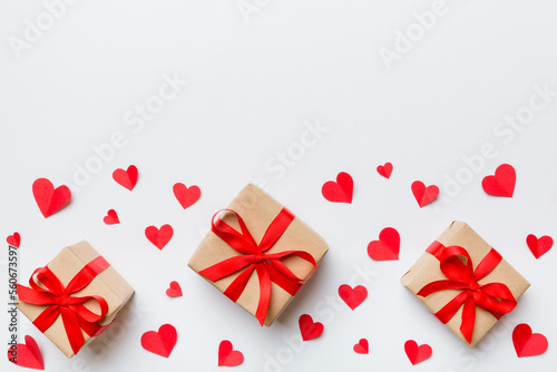 Valentine day composition  red gift box with bow and heart. Christmas present. View from above. Space for text. Holday greeting card