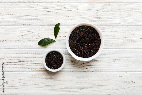 quinoa seeds in bowl on colored background. Healthy kinwa in small bowl. Healthy superfood