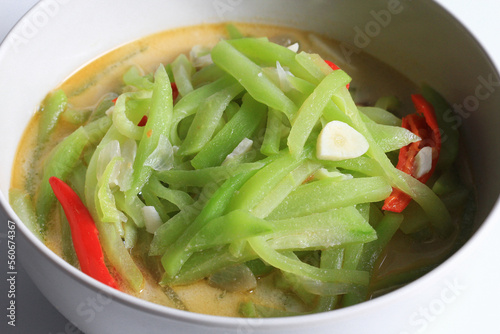 Sayur Labu Siam or  Sayur Manisa or Jipang or Chayote vegetable ,Indonesian food, made from slice of chayote cooked with spicy coconut milk, isolated on white background, close up view.
