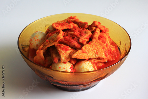Tahu bali or balinese seasoned tofu is Indonesian food made from fried tofu and eggs prepared with spices: shallots, garlic, large red chilies, brown and white sugar, isolated on white background.
