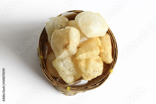 Rambak or Karupuak Jangek or Kerupuk Kulit  is a Indonesian Traditional Cattle or Cow Skin Cracker. Rambak in besek, isolated on white background, top view.