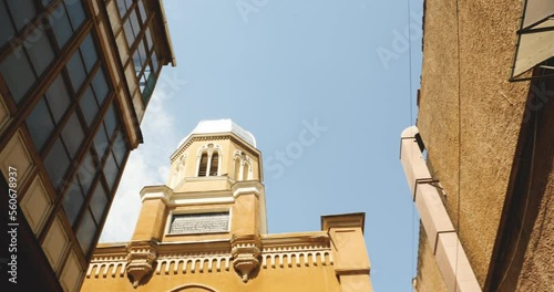 Pan over the tower of Biserica Sfanta Adormirea Maicii Domnului Church of the Holy Dormition of the Mother of God to old fresque with biblical scene photo