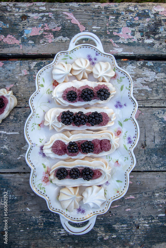 Dessert Anna Pavlova with fresh blackberries and buttercream.
