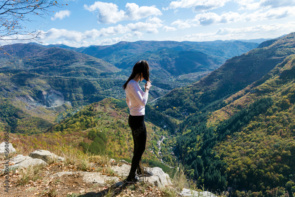 Traveler Woman standing  on a rocks  in the autumn  mountain with scenery view . Balkan mountains,  ,Bulgaria
