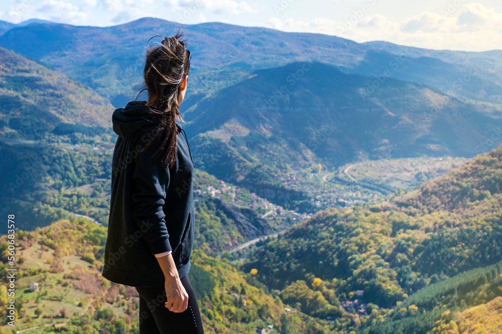 Traveler Woman standing  on a rocks  in the autumn  mountain with scenery view . Balkan mountains,  ,Bulgaria