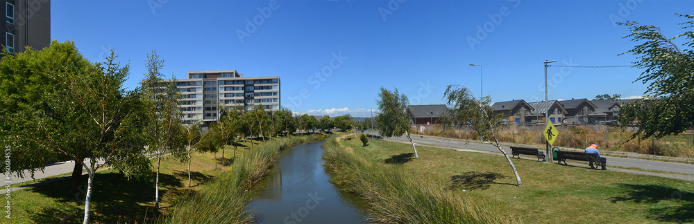 a beautiful river near a housing estate in the summer time