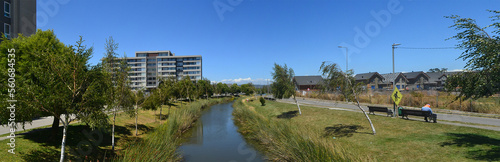 a beautiful river near a housing estate in the summer time © gustavo