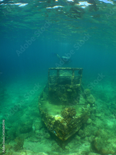 a small sunken ship in the crystal clear waters of the caribbean sea