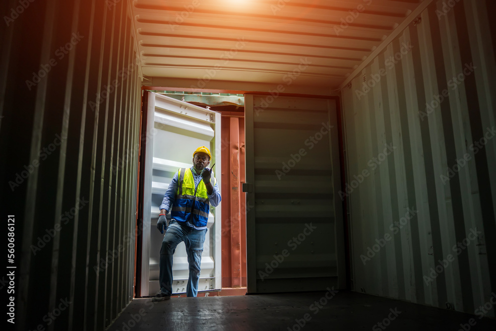 Technician working and inspecting cargo container in shipping yard,Container Shipping Logistics concept.