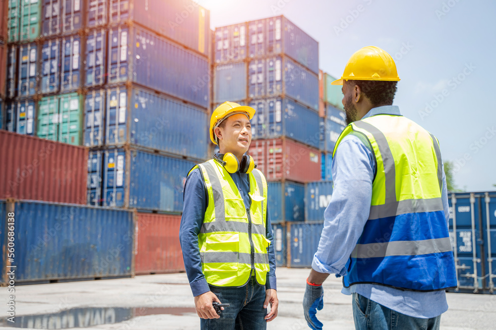 Engineer with foreman checking the container to prepare the delivery to the customer. Engineer with foreman checking the container to prepare the delivery to the customer.
