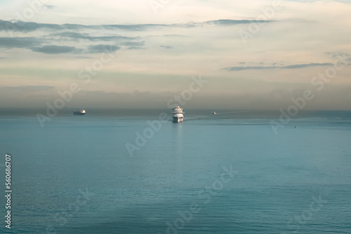 Cruise ship sailing on the Mediterranean Sea with a silhouette sunrise sky