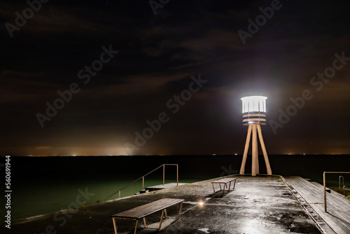 Copenhagen, Denmark A lighthouse at Bellevue Beach at night.  photo