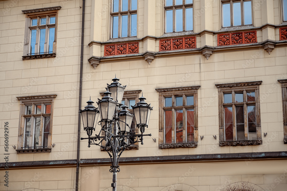 Close-up of an old street lamppost against a strange building. Lucky lantern europe