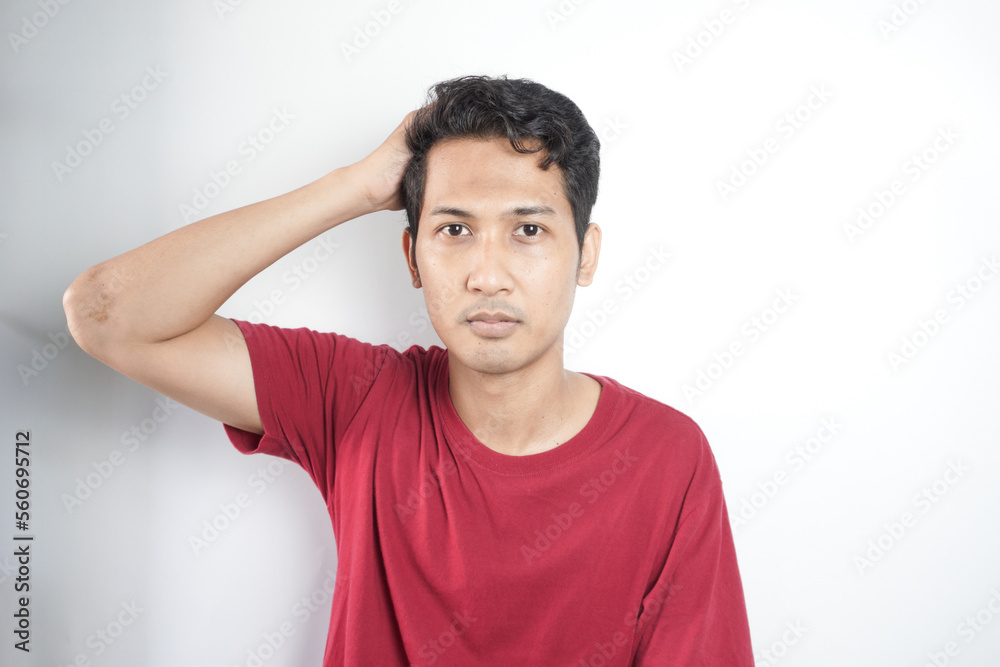 Young handsome man wearing casual t-shirt standing over white background confuse and wonder about question. Uncertain with doubt, thinking with hand on head. Pensive concept. Young handsome man wearing casual t-shirt standing over white background confuse and wonder about question. Uncertain with doubt, thinking with hand on head. Pensive concept.