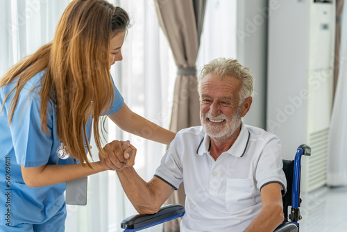 Man being cared for by a private Asian nurse at home suffering from Alzheimer's disease to closely care for elderly patients with copy space on left