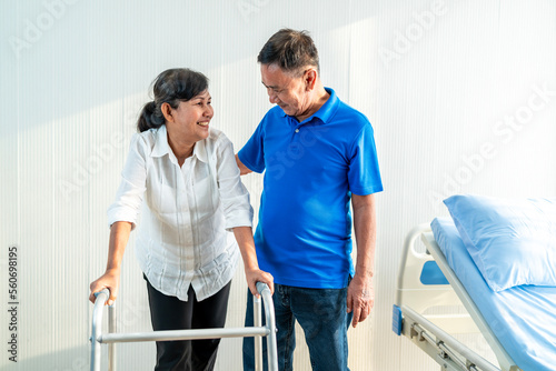 The husband is closely caring for his Asian wife who is being treated at the hospital. with love for each other, the concept of love for the elderly