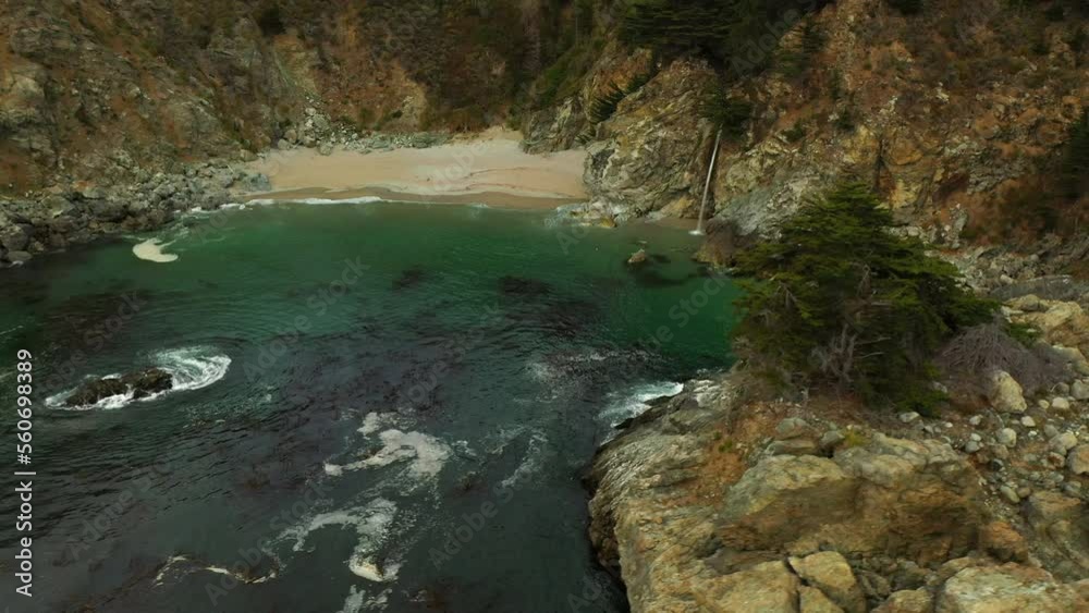 Aerial Panning Shot Of Waterfall Flowing On Mountain At Beach, Drone Flying Over Wavy Sea - San Francisco, California Aerial Panning Shot Of Waterfall Flowing On Mountain At Beach, Drone Flying Over Wavy Sea - San Francisco, California