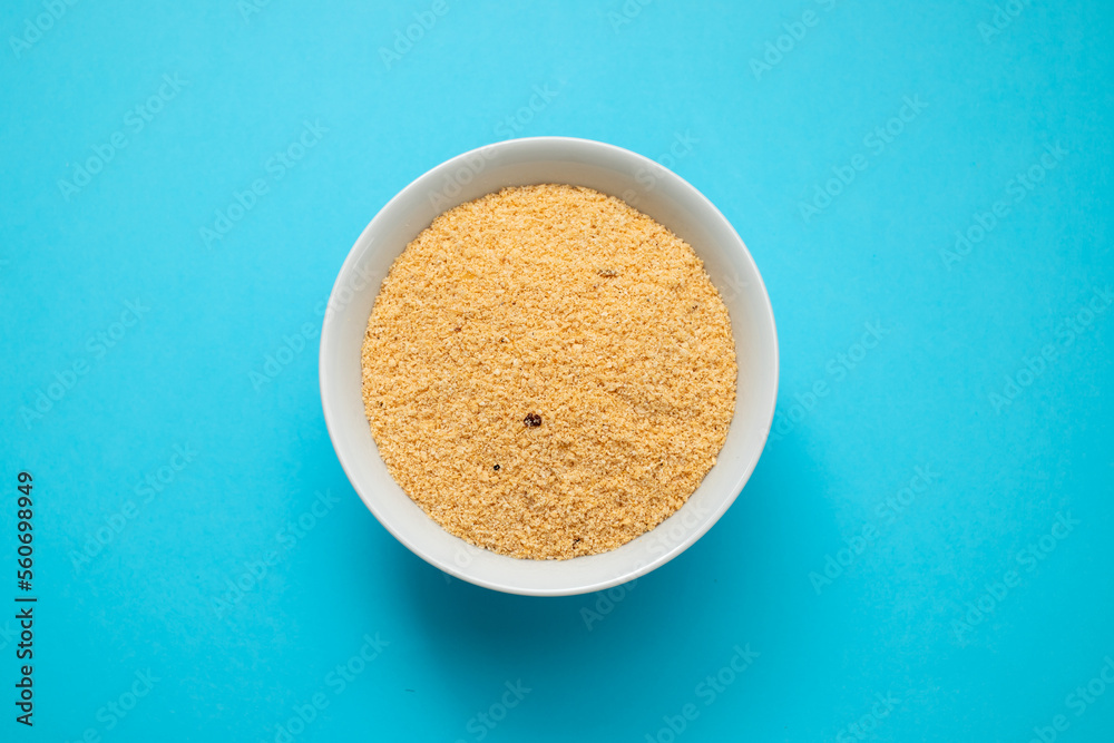 Farofa, typical brazilian manioc flour side dish on blue Farofa, typical brazilian manioc flour side dish on blue