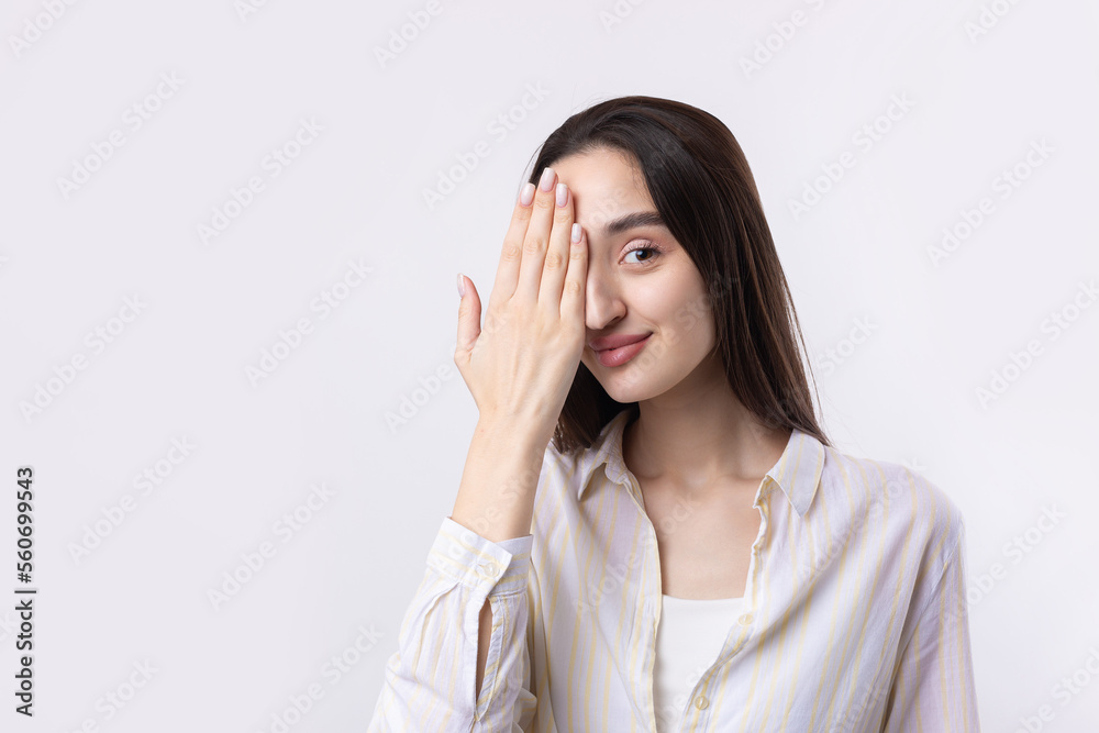 Portrait of a serious young woman showing stop gesture with her palm over white background Portrait of a serious young woman showing stop gesture with her palm over white background