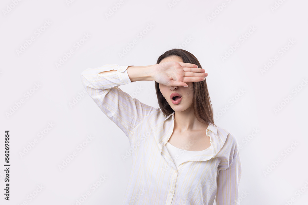 Portrait of a serious young woman showing stop gesture with her palm over white background Portrait of a serious young woman showing stop gesture with her palm over white background
