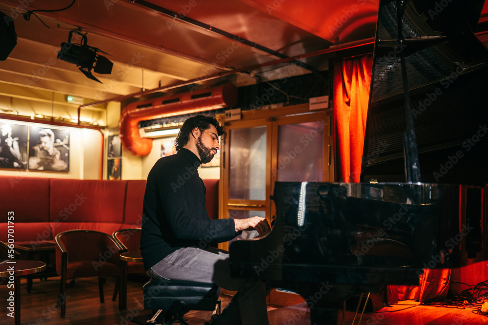 Man playing piano in a club Man playing piano in a club