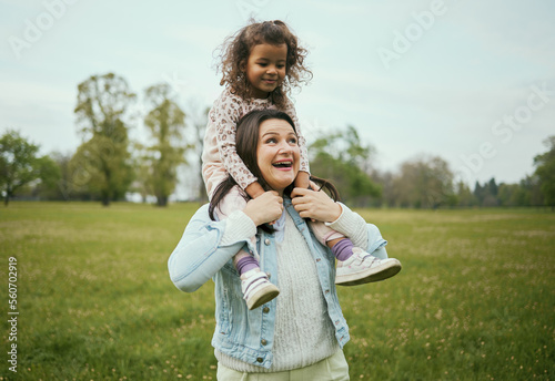 фотографія Mother, girl and sitting on shoulders in park for happiness, bonding or care in nature, walk or together outdoor