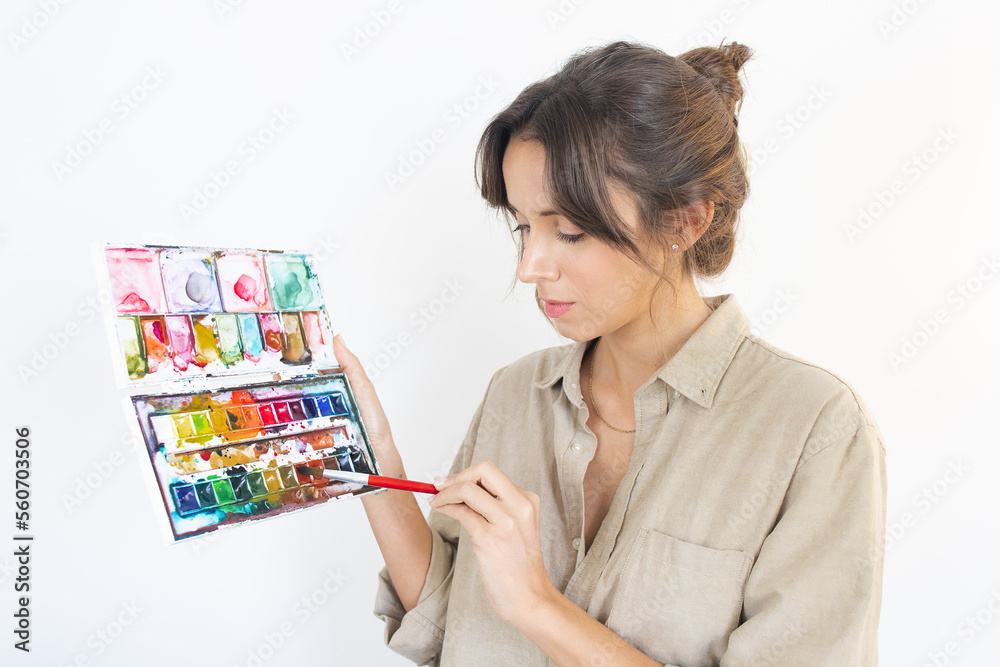 Person Holding Godet and Painting Brush