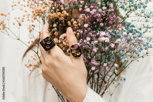 woman wearing floral epoxy rings photo