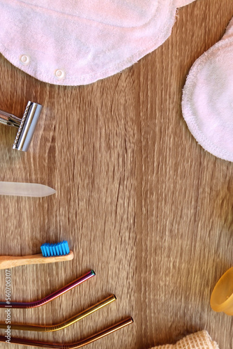 Various zero waste beauty products and kitchen utensils on wooden background. Top view.