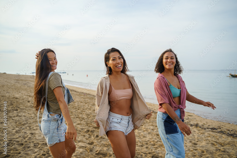 Diverse female friends dancing and having fun at beach Diverse female friends dancing and having fun at beach