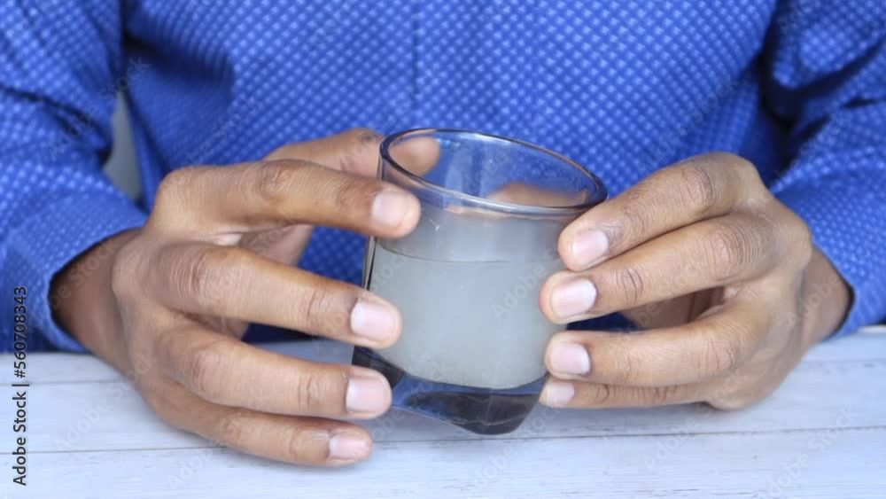 men holding dirty glass of water men holding dirty glass of water