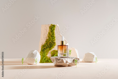 Serum and oil cosmetic bottle on a concrete stone with moss podium photo