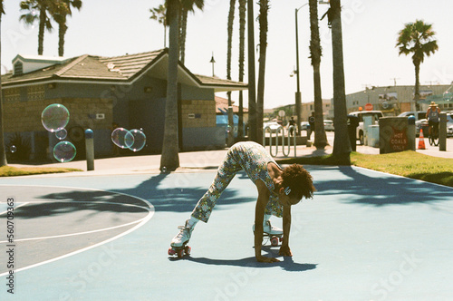 Girl catches bubbles while rollerskating