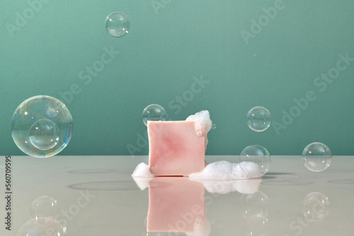 Cherry blossom soap on a reflective surface with soap bubbles foam photo