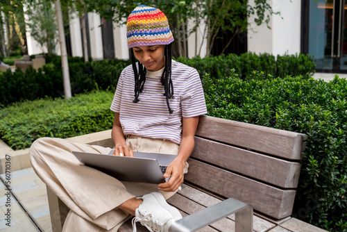 Happy student working on laptop