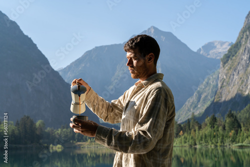 Man making coffee in nature photo