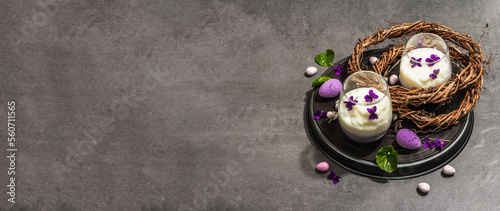 Happy Easter festive composition. Vegan panna cotta dessert with fresh violet flower
