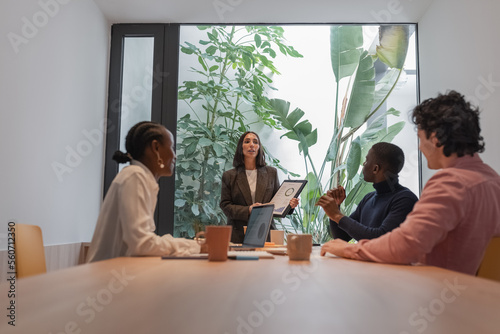 Diverse managers collaborating in light workplace photo
