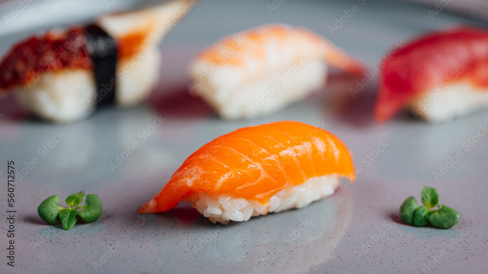 Close up of sashimi sushi set with chopsticks and soy, different sushi rolls on plate Close up of sashimi sushi set with chopsticks and soy, different sushi rolls on plate