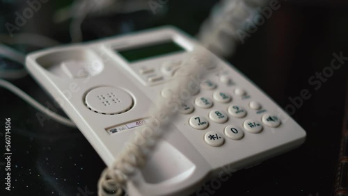 Worker Man hand office worker picking up the phone to answer a phone call whilst working at his desk. pick up the phone and answer the call. retro telephone. High quality 4k footage