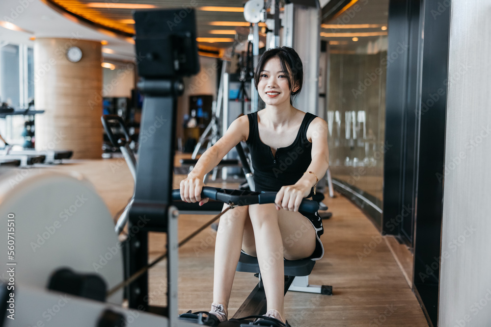female using a rowing machine in the gym female using a rowing machine in the gym