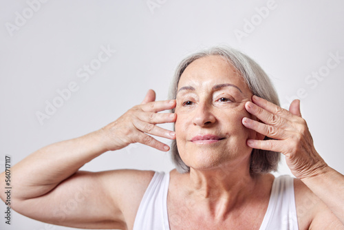 Female pensioner doing skin care routine