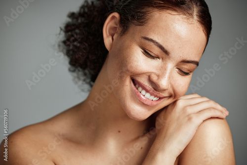 Face, beauty and skin with a model black woman in studio on a gray background to promote natural care. Facial, wellness and makeup with an attractive young female happy with her skincare product