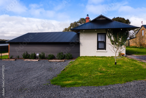 gravel car park in front of small cottage photo