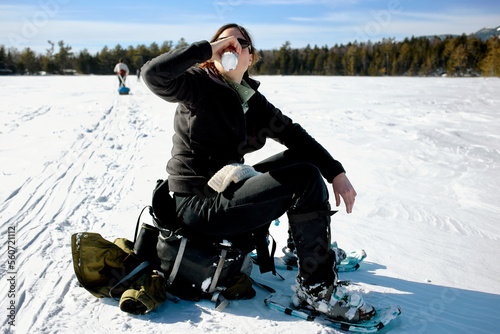 Women drinks a beer on a Frozen Lake