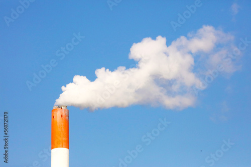 Smoke coming out of the chimney against the blue sky