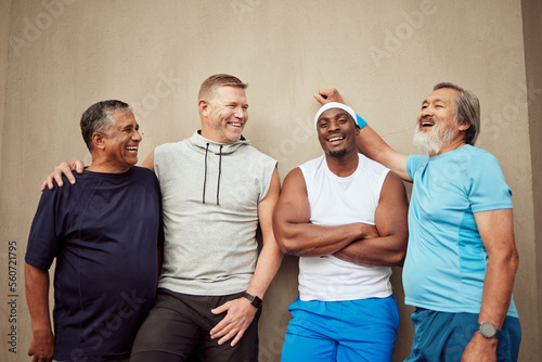 Happy men, exercise group and laughing in city on wall background outdoors. Smile, fitness and mature male friends with happiness for workout, wellness support and sports energy for healthy lifestyle photo