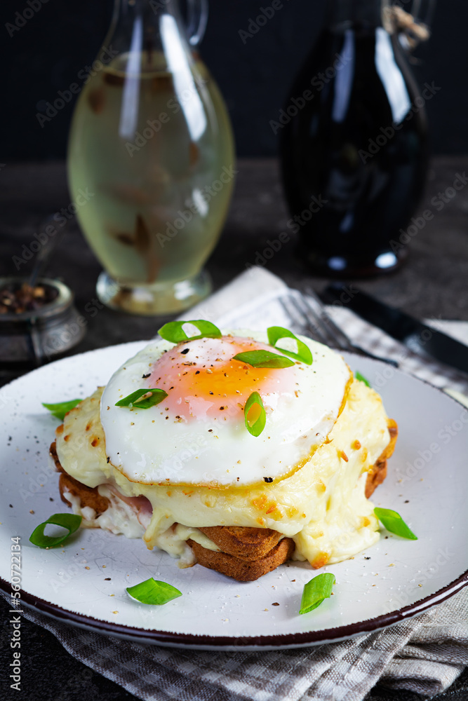 Delicious breakfast. Hot french toast with ham and bechamel sauce - croque madame Delicious breakfast. Hot french toast with ham and bechamel sauce - croque madame